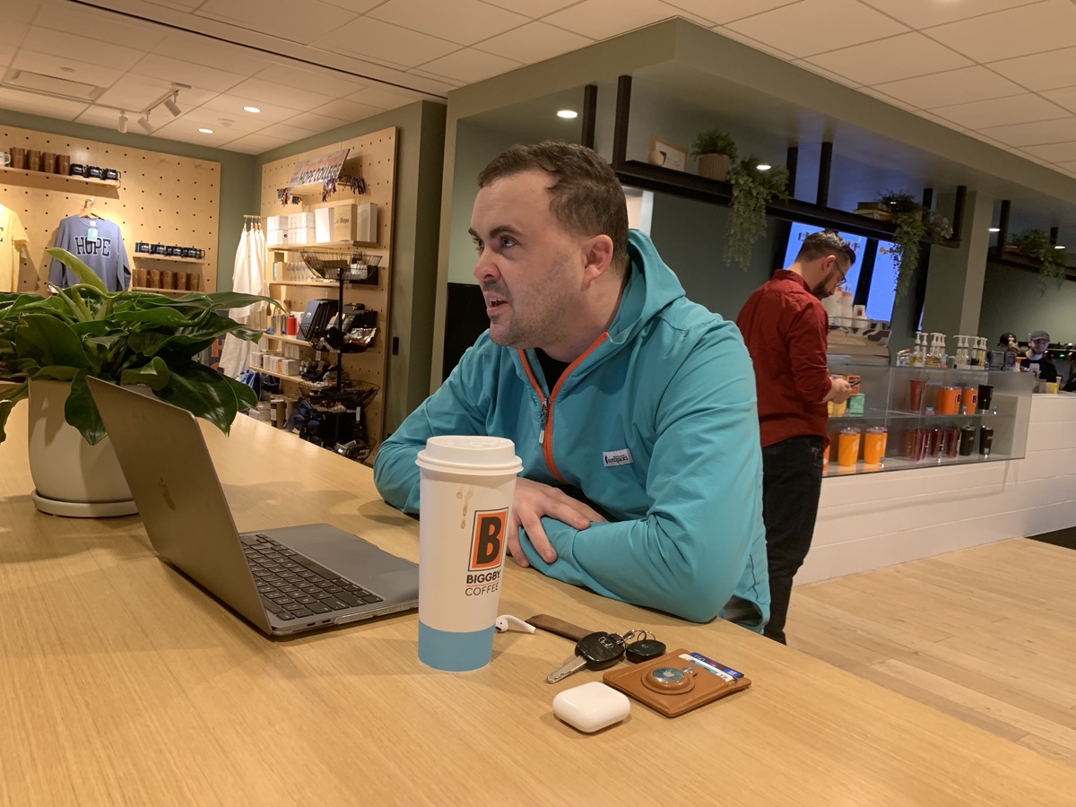 Tim Haines working at a coworking space with laptop